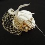 White and gold mini top hat with gold veil White and gold mini top hat with gold veil
