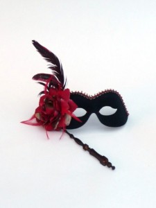 Black folding stick mask with red feather and red rose